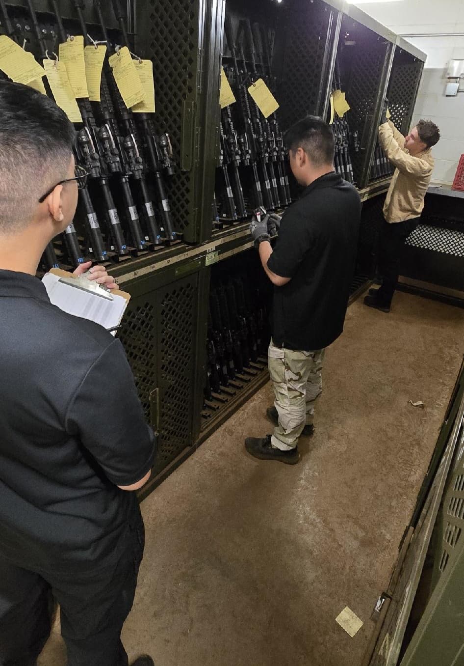 WBSI personnel conducting a weapons inventory in the armory