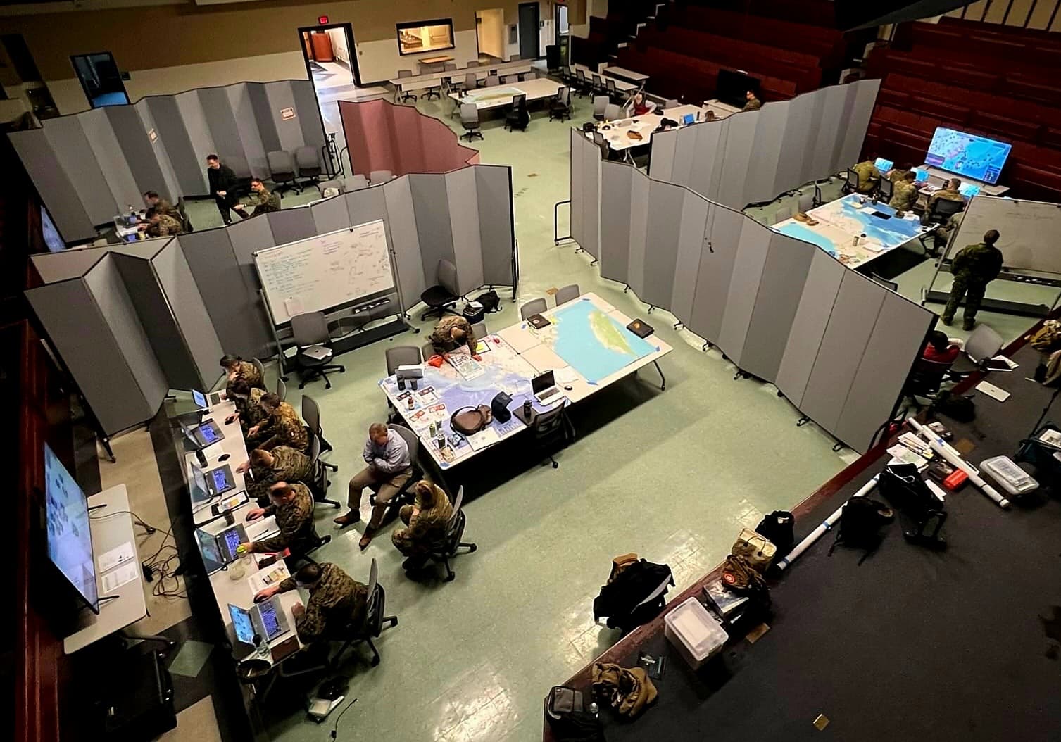 A Marine Corps University wargaming event spanning an auditorium floor